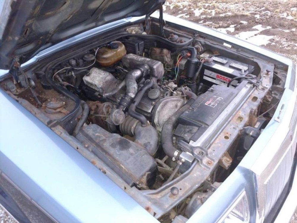 Dirty car engine bay before detailing